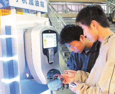 Chinese consumers charging their mobile devices with a coin-operated kiosk by ChaliYuan.